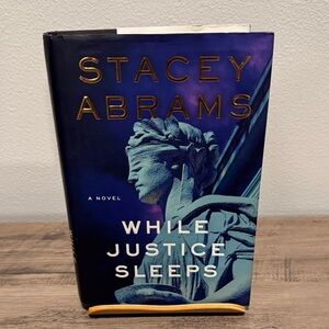 Stacey Abrams 'While Justice Sleeps' Book - Blue Cover